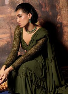 Embrace elegance with this olive branch embroidered blouse and ruffle sari set. The intricately embroidered full-sleeve blouse adds a touch of sophistication, perfectly complementing the graceful drape of the sari. The ruffle detailing enhances the overall look, creating a beautiful silhouette that’s ideal for special occasions. This ensemble beautifully merges traditional charm with modern style, ensuring you shine with confidence and grace. Full Sleeve Blouse, Beautiful Silhouette, Satin Color, Olive Branch, Embroidered Blouse, Traditional Design, Full Sleeve, Modern Style, Sleeve Blouse