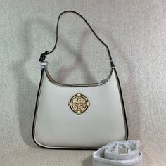 Brand New Never Been Carried Small Convertible Miller Hobo By Tory Burch. This Bag Is Made Of Ivory Genuine Leather Dimensions: 7.6" Wide X 11.2" Tall Center X 2.4" Deep. Wear As A Shoulder Bag With 7.2" Strap Drop Or Crossbody Bag With Extended 22.5" Drop Strap. Comes With Adjustable And Detachable Long Strap. Hidden Magnetic Button Closure Leather Logo Interior: 1 Zippered And 1 Slip Pocket Micro Fiber Lining. Brass Tone Metalware. High-end White Shoulder Bag, Luxury White Bag With Palladium Hardware, Designer White Shoulder Bag With Detachable Strap, White Rectangular Shoulder Bag With Gold-tone Hardware, White Hobo Shoulder Bag With Removable Pouch, High-end Cream Shoulder Bag, Designer White Shoulder Bag With Palladium Hardware, High-end White Shoulder Bag For Shopping, Luxury Beige Hobo Bag With Dust Bag