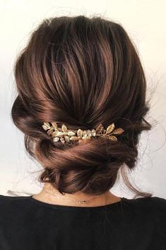 a woman is wearing a gold hair comb