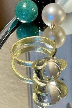 Rare 14k BRUTALIST MODERNIST POOLS OF LIGHT ROCK CRYSTAL GLASS ORB Ring!  in excellent condition! arrives in jewelry case and can be gifted immediately! crafted in solid 14k yellow gold and comes with 10 different gemstone spheres - each approx 10mm. there are natural gem orbs:  -moonstone with blue sheen (the moonstone is approx 7.55Ct please see photo for its carat weight), -South Sea Pearl wit diamond, -agate - eye like pattern( please see photos),  -lapis,  - golden sand stone,  -amethyst, Modern Gold Crystal Ring With Gemstone, Modern Yellow Gold Round Moonstone Ring, Modern Gold Crystal Ring Gift, Modern Gold Crystal Ring For Gift, Modern Gold Moonstone Ring For Formal Occasions, Modern 14k Gold Moonstone Ring For Formal Occasions, Modern Gold Moonstone Rings, Gold Moonstone Ring In 14k Gold, Gold Moonstone Ring For Formal Occasions