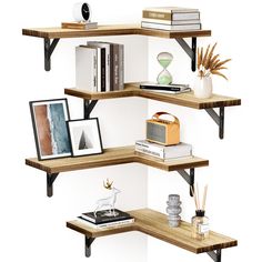 three wooden shelves with books and pictures on them