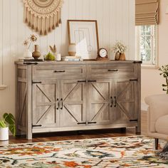 a living room area with a rug, chair and sideboard in front of a fireplace