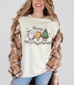 Celebrate the festive season in style with this cozy Hellothanksmas Shirt -- the perfect blend of Halloween, Thanksgiving and Christmas Cheer! Whether you're  enjoying a Halloween Party or Thanksgiving feast or wrapping Christmas presents, this Holiday Tee covers all the bases in one fun crewneck. Featuring playful elements from all three holidays, it's the perfect way to kick off the holiday season with humor and warmth. Crafted from soft, premium fabric, this tshirt offers all-day comfort and Casual Fall Holiday T-shirt, Casual T-shirt For Fall Holiday, Casual Halloween Holiday Tops, Holiday Crew Neck Tops For Fall, Cotton T-shirt For Fall Holiday, Holiday Letter Print T-shirt For Fall, Graphic Print Tops For Fall Holiday Season, Graphic Print Tops For Holiday In Fall, Graphic Print Tops For Fall Holiday