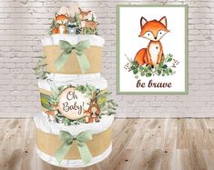 a three tiered baby shower cake decorated with woodland animals