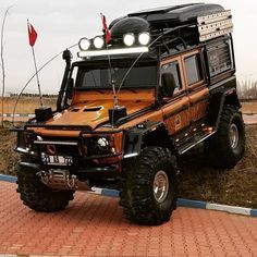 an off - road vehicle is parked on the side of the road with its lights on