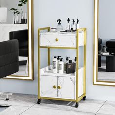 a white and gold shelf with bottles on it in front of a mirror that has a black chair next to it