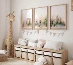 a living room with white walls and pillows on the floor, two giraffes in the background