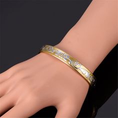 Keep calm and shine on wearing this gleaming two-tone bauble sure to add an instant splash of glam to your everyday ensembles. 0.37'' W 18k gold-plated copper / platinum-plated copper Classic Bangles, Floral Cuff, Open Cuff Bracelet, Vintage Bangles, Open Bangle, Cuff Bangle Bracelet, Magnetic Bracelet, Gold Pattern, Classic Gold