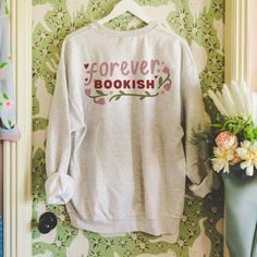 👕 **Features - Soft, premium fabric for ultimate comfort Whether you're curled up on the couch or heading to the local bookstore, this sweatshirt is your new go-to! Let the world know your heart belongs to the pages.  Grab yours today and wear your bookish heart on your sleeve! ❤️📖 **Size OptionsXS, S, M, L, XL, 2XL, 3XL **Care Instructions Machine wash cold, tumble dry low.  ✨ *Bookish vibes only!* ✨ Relaxed Fit Bookish Sweatshirt For Fall, Bookish Cotton Sweatshirt With Letter Print, Cotton Letter Print Bookish Sweatshirt, Bookish Cotton Sweatshirt For Winter, Winter Bookish Cotton Sweatshirt, Bookish Long Sleeve Relaxed Fit Sweatshirt, Winter Cotton Sweatshirt, Local Bookstore, Book Club Shirt