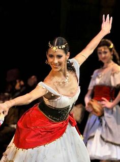 a woman in a costume is dancing on stage