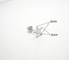 This earring is comprised of 92.5% Sterling Silver and is Rhodium plated to improve the finish and appearance of the earring. Process of Rhodium plating allows for a brighter finish, similar to white gold, and it helps to prevent tarnish which is prevalent in silver, while providing the added benefit of being scratch resistant. The earring is secured by a screw back, which needs to be screwed onto the pin behind the earlobe, as opposed to being pushed into the backing. This also provides added s Nickel Free Silver Star-shaped Piercing, Nickel-free Silver Star Piercings, Nickel-free Star-shaped Silver Piercings, Silver Star Single Stud Earring, Nickel Free Star Shaped Silver Cartilage Earrings, Hypoallergenic Adjustable Star Earrings, Screw Back Earrings, Rhodium Plated