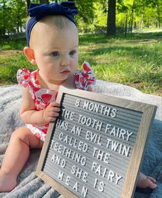 a baby sitting on top of a blanket holding a sign that says 8 months the tooth fairy has an evil twin called the ceiling