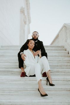 a man and woman are sitting on some steps