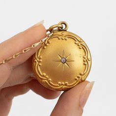 "This antique gold filled Edwardian or Victorian necklace features a photo locket pendant decorated in Art Nouveau repousse of a starburst around a paste gemstone. It hangs on n unusual and seemingly gold plated or filled chain. This item is not marked.   This locket measures about 1 1/8 inches in diameter (not including its bail) while its chain is about 24 inches long. The locket does not have locket frames or covers. It closes with a strong \"snap\"." Keepsake Yellow Gold Brass Locket Necklace, Keepsake Yellow Gold Locket Necklace In Brass, Yellow Gold Brass Locket Necklace For Keepsake, Gold Locket Necklace With Intricate Round Pendant, Gold Locket Necklace With Intricate Design And Round Pendant, Gold Locket Necklace With Intricate Design, Gold Medallion Locket Necklace For Memorial, Gold Engraved Heirloom Locket Necklace, Antique Gold Necklaces For Keepsake