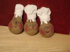 three painted bowling balls sitting on top of a wooden table next to a red carpet