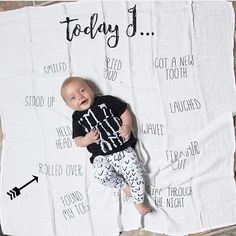 a baby laying on top of a blanket with the words today 5 printed on it