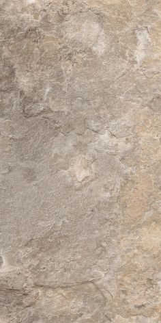 a close up view of a tile floor with brown and tan colors on the surface