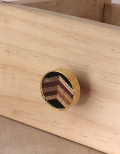 a close up of a wooden object with a metal knob