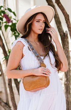 Fall in love with the Amelia, a classic crossbody that went viral on TikTok—and for good reason! It's that's complete with special details that make this beauty extraordinary. You'll swoon over the braided zipper pulls, dreamy desert-inspired color choices, and buttery vegan leather. This boho crossbody has the space and organizational features for all that you'll need on the go, including a back zippered pocket for smaller must-haves and two interior pockets inside the spacious interior. The wo Summer Crossbody Bag Strap, Chic Summer Bag Strap With Detachable Strap, Long Strap Bag For Summer, Bohemian Bag Strap For Everyday Use, Beige Leather Trim Crossbody Bag, Everyday Crossbody Shoulder Bag With Fringe, On-the-go Crossbody Camera Bag With Zipper Pocket, Cowhide Fringe Crossbody Bag, Tan Crossbody Bag With Silver-tone Hardware