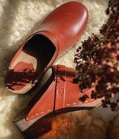 The best clogs for all occasions. Stylish with a nod to the past and an eye towards the future. With a handcrafted design, versatile colors, and comfortable wooden soles, these classic wooden clog mules will last you for years to come. Clog measurements:Heel height: 1 3/4” (4.5 cm)Toe height: 1 5/8″ (4.1 cm)Fit:RegularLeather:Vegetable tanned leatherClogs consist of:Base: European Lime WoodSole: Rubber soleFastening: Staples Clogs Women, Clog Mules, Cork Sandals, Wooden Clogs, Clog Sandals, Womens Clogs, An Eye, Boot Shop, Shop Sandals