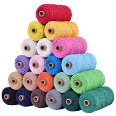 several spools of thread are stacked on top of each other in different colors