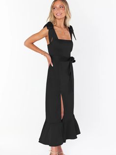 Make a daring statement in our AVIANCA Shoulder Tie Bridal Midi Dress in Black. This alluring bridal inspired midi dress features the signature AVIANCA shoulder tie detailing and rich claret fabric with a delicate shimmer, creating a sophisticated and exclusive look for the fashion-forward bride. Crafted with a luxurious feel, this dress is sure to dazzle on your special day or wedding guests. Size Guide: Model is 5’6” tall, and has a 33.4” bust, 26.5” waist, & 34.6” hips. She is wearing a S / U High Split Dress, Candle Dressing, Split Dress, Wedding Watch, Versatile Dresses, Wedding Guests, Black Midi Dress, Tank Shirt, Tank Top Shirt