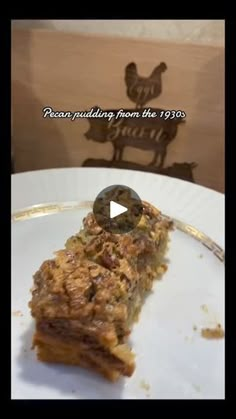 a piece of cake sitting on top of a white plate next to a wooden sign