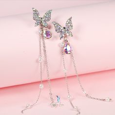 This is a a pair of charming, dazzling, beautiful made dangle drop earrings, in the shape of sweat purple butterfly with cubic zirconia pave and a tear drop push back, a long trail with artificial pearls on one earring to add charisma to this pair of butterflies earrings. Jewelry Care: See more information about how to care for your jewelry here. Shipping Policy: Orders will be shipped within 1-3 business days. Economy shipping will take 7-14 days to arrive and standard shipping is 1- 4 days for Party Jewelry With Butterfly Dangle Charm, Butterfly-shaped Rhinestone Party Jewelry, Party Jewelry With Rhinestones And Butterfly Shape, Party Jewelry With Rhinestones In Butterfly Shape, Butterfly-shaped Party Jewelry With Rhinestones, Butterfly Shaped Party Jewelry With Rhinestones, Purple Butterfly Charm Jewelry For Party, Elegant Purple Butterfly Earrings, Silver Butterfly Charm Earrings For Party