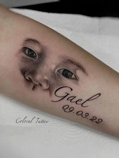 a close up of a person's arm with an eye and date tattoo on it