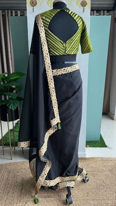 Product Descriptions : Black soft organza saree with golden rich cutwork border is paired up with olive silk banarasi blouse. This ensemble is perfect for special occasions, offering an elegant look without sacrificing comfort. The organza material is lightweight and breathable, while the rich cutwork border adds a subtle yet stunning detail. View this post on Instagram A post shared by Shobana_Nithin_Threads (@threadslabel_india) Formal Bollywood Organza Pre-draped Saree, Elegant Cotton Silk Traditional Wear For Party, Elegant Party Traditional Wear In Cotton Silk, Elegant Organza Blouse With Zari Work, Elegant Cotton Silk Pre-draped Saree With Border, Elegant Formal Organza Saree, Elegant Pre-draped Organza Saree, Elegant Organza Pre-draped Saree, Elegant Festive Pre-draped Saree With Border