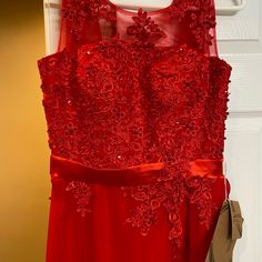 a red dress hanging up on a door