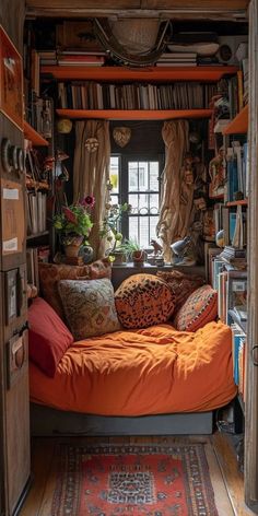 an orange bed in the corner of a room with lots of bookshelves and plants