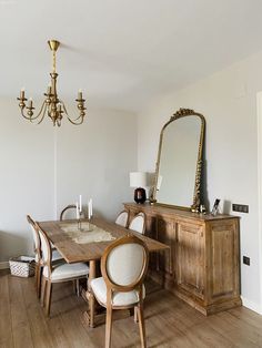 a dining room table with chairs and a chandelier