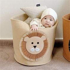 a baby is laying in a lion shaped basket