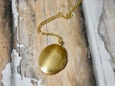 This gold oval locket necklace is a great keepsake necklace. It opens for your favorite two photographs. You will need to find a photo that fits and glue it into place. We do not place the photo in for you and at this time we do not engrave. It's the perfect gift for all ages. These lockets are not vintage, they are new. Unfortunalty it is very difficult to find vintage lockets. I T E M • DETAIL: - PENDANT SIZE: Outside measurements 7/8" x 1 1/4", Inside measurement 5/8 x 7/8 - CHAIN LENGTH: 16" Gold Oval Pendant Locket Necklace For Personalized Gift, Gold Oval Locket Necklace For Personalized Gift, Oval Gold Locket Necklace For Personalized Gift, Antique Gold Oval Locket Necklace For Keepsake, Gold Oval Locket Necklace For Keepsake, Personalized Gold Locket Necklace With Oval Pendant, Oval Pendant Locket Necklace With Adjustable Chain For Keepsake, Gold Oval Pendant Locket Necklace For Keepsake, Antique Gold Oval Locket Necklace For Gift