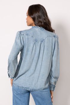 Finished with ruffles at the collar and cuffs, the Alanna Shirt by Rails is crafted in soft lyocell-blend denim with a seamed yoke, front snap closures, and long puff sleeves. Tuck into cargo pants, or pair with jeans for a denim-on-denim look. | RAILS Women's Alanna Shirt, Size XS, Blue Long Sleeve Denim Blue Top With Ruffles, Long Sleeve Denim Top With Ruffles, Blue Ruffled Long Sleeve Denim Top, Blue Long Sleeve Denim Top With Ruffles, Casual Denim Blouse With Ruffles, Casual Denim Ruffle Blouse, Denim Blue Ruffled Tops For Fall, Denim Ruffled Long Sleeve Tops, Long Sleeve Washed Blue Denim Top With Frayed Hem