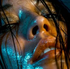 a woman with blue glitter on her face