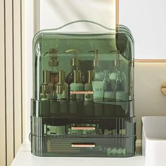 an assortment of different types of toothbrushes in a clear container on a counter