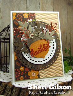 a close up of a card on a table with a birdcage in the background