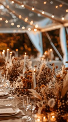 the table is set with candles, flowers and place settings for an elegant wedding reception