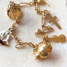 A vintage 9 carat gold charm bracelet complete with six individual charms. The adorable charms include a Cross, Kangaroo, Violin, Jug, Bird cage, sail boat.CONDITION: Good condition, wear consistent with it’s age and use. Please see photos for more detail.APPROX. LENGTH: 210mmWEIGHT: 9.5gTHANK YOU FOR LOOKING.