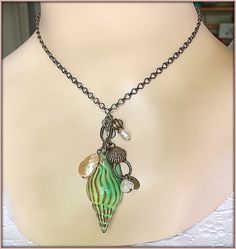 "* If you love the sea, you'll love this Nautical Necklace * A richly enameled Brass Pendant in the form of a True Tulip Seashell, 2\" (50mm) in length, in a gorgeous shade of Sea Green with Sandy Brown highlights * Long, interesting Chain Necklace, available in several lengths; please select your favorite * All Natural Pearls, both Freshwater and Coin Pearl, dangling with Bronze Charms * This beautiful Beach Necklace will be gift wrapped in a lovely gift box. Thank you for visiting my shoppe! N Sandy Brown Highlights, Resort Jewelry, Nautical Necklace, Jewelry Beach, Beach Necklaces, Bronze Necklace, Nautical Jewelry, Coin Pearls, Necklace Long