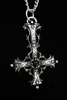 The Traumaturgist's Cross is a handcrafted piece made from fine pewter, containing 98% tin, featuring an intricate gothic inverted cross design that measures 7 cm in height. This pendant is adorned with a gemstone of your choice, allowing for personalization and enhancement of its significance. It comes with a choice of a stainless steel chain in either 18 or 24 inches, ensuring durability and hypoallergenic properties. The inverted cross is a powerful symbol often associated with the themes of Gothic Bronze Jewelry With Antique Finish, Gothic Metal Necklace With Antique Finish, Gothic Cross Jewelry As Gift, Gothic Cross Jewelry Gift, Gothic Cross Jewelry For Gifts, Gothic Engraved Bronze Jewelry, Gothic Metal Jewelry With Antique Finish, Gothic Bronze Engraved Jewelry, Vintage Cross Necklace With Antique Finish