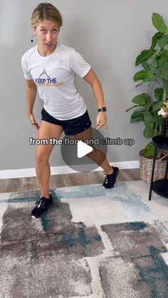 a woman standing on top of a rug holding a tennis racquet