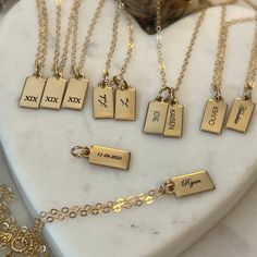 "Personalized Gold Rectangle Pendant Necklace from our Memoirs Made Collection. Personalize a short word or up to three initials on the lovely 14k gold filled tag necklace Free Engraving for a limited time! NECKLACE DETAILS * 14k gold-filled or 925 sterling silver * Matching cable chain in your choice of 16\", 18\" or 20\" length * Tag measures 13.5mm x 6mm (.53\" x .23\") * Spring ring clasp closure * Choice of several fonts and design layouts * 1 - 3 characters will fit across the tag, we can 14k Gold Filled Yellow Gold Charm Necklace For Anniversary, Yellow Gold Nameplate Initial Necklace, Classic Gold Jewelry With Initials, Customizable Yellow Gold Charm Necklaces With Nameplate, Gold Nameplate Necklace Stamped 14k, Customizable Yellow Gold Nameplate Charm Necklaces, Classic Gold Initial Necklace For Mother's Day, Gold Engraved Initial Necklace In Sterling Silver, Customizable Gold Nameplate Initial Necklace