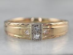 a close up of a wedding ring with diamonds on the bottom and in the middle