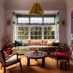 a living room filled with furniture and windows