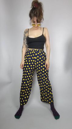 You are looking for a comfy but also stylish summer pants? These wonderful darkblue midi pants are printed with big yellow dots that bring the sunshine right to you.  DETAILS: no size label, seems like S, check measurements below navy blue with yellow polkadots wide leg style comfy fit elastic waistband light summer fabric Vintage condition: VERY GOOD there is a tiny irritation in the fabric at one side and small hole above it at the waistband  length: 95cm waist width: 30 - 45cm (stretchy) wais Summer Polka Dot Pants With Elastic Waistband, Polka Dot Wide Leg Pants With Elastic Waistband, Polka Dot Wide-leg Pants With Elastic Waistband, Retro Straight Pants Relaxed Fit, Retro Relaxed Fit Straight Pants, Relaxed Fit Retro Straight Pants, Fitted Polka Dot Bottoms With Elastic Waistband, Casual Polka Dot Bottoms For Summer, High Waist Polka Dot Bottoms With Elastic Waistband