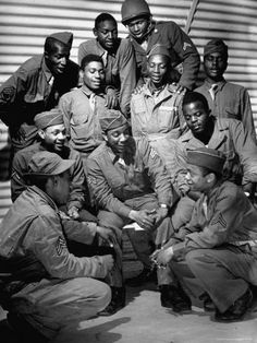 an old black and white photo of men in uniforms