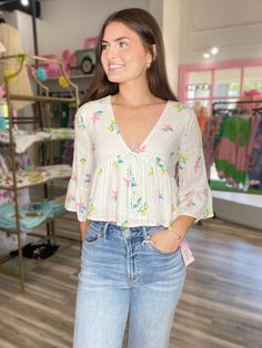 Say goodbye to boring wardrobe with our Spring Cleaning V Neck Peplum Top! Featuring a playful lemon and flower design, this top adds a pop of color to any outfit. The peplum design adds a flattering touch. Time for some fun in the sun! Cute V-neck Blouse For Vacation, Summer Feminine Floral Print Peplum Top, Feminine Floral Print Peplum Top, Summer Long Sleeve Tops With Floral Print, Spring Beach Peplum Top, Cute Yellow Spring Blouse, Summer V-neck Peplum Top For Brunch, White Casual Peplum Top For Day Out, Spring Floral Print Feminine Peplum Top